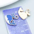 Close-up detail of a blue and white whale enamel charm next to a purple measuring ruler. - Ocean Whale Style (11029) / 1 Piece (14x13mm)