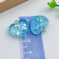 Ciondolo a cuore in resina blu lago con stelle per accessori gioielli fai da te - Cuore in Resina Glitter Blu Trasparente (24319) / 1 Pezzo (17*18mm) / Blu