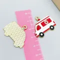 Red and white enamel alloy ambulance charm pendant shown with ruler for size reference - Red Ambulance Shape