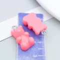 Pink gummy bear resin charms for DIY jewelry making, shown with ruler for scale. - Bear Candy (12575)