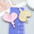 Two pink heart lollipop enamel alloy charms shown with scale ruler for DIY jewelry making - Heart Lollipop (21124)