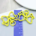Vibrant yellow bow-shaped alloy lobster clasp keychain hook shown with a ruler for size measurement - Bowknot Keychain (26114) / 1 Piece (33x39mm) / Yellow