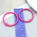 Vibrant pink spray-painted loose-leaf book ring for DIY crafts shown next to a ruler for scale - Rose Red Painted (26254) / 1 Piece (30mm/25mm)