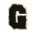 Close-up of black chenille letter G patch with gold glitter border for DIY clothing crafts. - Letter G
