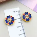Detailed macro shot of blue and red enamel flower charms next to a ruler for size - Four-Leaf Clover (22504) / 1 Piece/Pack (13x13mm) / Dark Blue