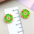 Close-up of green and red enamel cherry blossom clover beads with ruler for scale. - Four-Leaf Clover (22505) / 1 Piece/Pack (13x13mm) / Green