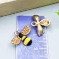 High-quality yellow enamel bee charm for DIY jewelry crafts shown with ruler for size - 1 Piece/Pack (14x17mm)