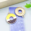 Colorful enamel alloy donut charms for DIY necklace making shown on blue metric ruler - 1 Piece/Pack (18x15mm)