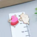 DIY gold-plated pink and red enamel heart charms shown with a ruler for size reference - Double Heart Cupid's Arrow (25206) / 1 Piece (12*17*1mm) / Red Pink