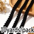 Close up of black pom pom fringe trim, 10 yards per pack, ideal for DIY sewing and apparel decor. - Black