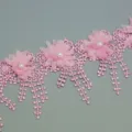 Pink lace trim detail closeup with 3D chiffon flowers and faux pearls for crafts decoration. - Pink