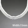 White elastic lace trim detail shot displaying fine floral pattern and 15mm width specs. - 15mm