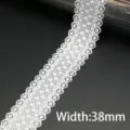 Close-up detail of the 38mm white elastic lace trim, showing delicate hollowed pattern. - 38mm