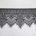 Detailed view of exquisite black eyelash lace trim fabric, delicate floral pattern for DIY. - Black