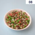 Detailed view of red and green cracked acrylic beads in a pink bowl for DIY jewelry making. - 8#
