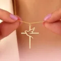 Close-up of gold stainless steel cross necklace with a hollow peace dove pendant detail - Gold