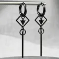 Close-up detail of black punk gothic earrings featuring a geometric diamond frame and long tassel - Square Cone Tassel Style / Black