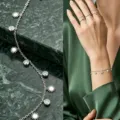 Elegant stainless steel bracelet with star and crystal charms shown on a model's wrist - Sun Pendant / Silver