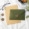 Detail shot of vintage avocado green envelope and lined letter paper set with wax seal. - 1 Olive Green Envelope + 1 Kraft Lined Paper + 1 Wax Seal Stamp