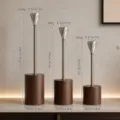 Set of three Nordic style aluminum candle holders with wooden bases in various heights. - Diamond Style