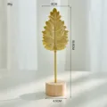Elegant gold iron leaf ornament with a natural wooden base for modern home decor - Y04 Leaf Ornament / Gold
