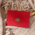 Detailed shot of retro red textured envelope with golden wax seal for romantic letters. - Bright Red Envelope 1pc + Stamp 1pc