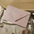 Detailed shot of retro pink tree texture paper envelope with natural leaves and wood tray. - 1 Wood Grain Sakura Pink Envelope / Sakura Pink