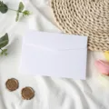 Vue détaillée d'une enveloppe en papier blanc propre avec des accessoires de décoration. - 1 enveloppe blanc poire