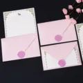Detailed view of pink envelopes with purple wax seals and gold-bordered letter paper. - 3 Pink Envelopes + 10 Sheets of White Rabbit Letter Paper + 3 Pink Wax Seals