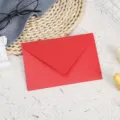 Red shimmering pearl paper envelope, classic flap design for greeting cards and letters. - Sparkling Red Gold