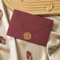 Close-up detail of vintage dark red envelope with golden wax seal for romantic letters. - 1 Cashmere Jujube Red Envelope & 1 Wax Seal
