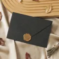 Retro black paper envelope detail close-up with gold wax seal for vintage stationery. - 1 Cashmere Charcoal Black Envelope & 1 Wax Seal