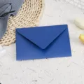 Close up of a dark blue shimmering envelope with pearl finish for wedding invitations. - Navy Blue