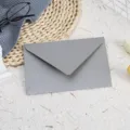 Close-up detail of a minimalist grey pearlescent paper envelope, elegant texture for stationery. - Silver Gray