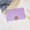 Detail view of a elegant light purple pearlescent envelope with a golden wax seal. - Light Purple with 1 Bronze Wax Seal / Light Purple