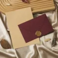 Close-up detail of retro stationery set featuring dark red envelope and vintage kraft paper. - Cashmere Wine Red: 3 Envelopes, 10 Kraft Lined Letter Sheets and 3 Wax Seals