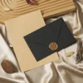 Close-up detail of vintage style stationery set featuring black envelope, wax seal, and kraft paper. - Cashmere Charcoal Black: 3 Envelopes, 10 Kraft Lined Letter Sheets and 3 Wax Seals