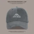 Close-up detail of the dark gray washed cotton baseball cap with embroidered mountain logo. - Gray