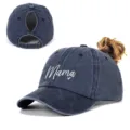 Detailed view of women's washed navy ponytail cap featuring 'Mama' heart embroidery - Adjustable / Navy Blue