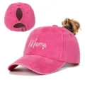 Close-up detail of a washed pink ponytail baseball cap featuring Mama heart embroidery. - Adjustable / Rose Red
