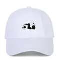Detailed macro view showing the cute panda embroidery on the front of a white baseball cap - Adjustable / White