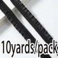 Detailed view of black ruffled elastic trim, 1cm wide stretch ribbon for sewing and DIY crafts. - Black