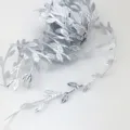 Silver leaf ribbon trim detail showing the exquisite embossed leaf vine texture closely. - Silver
