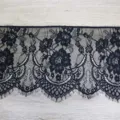 Detail view of black floral lace trim with delicate eyelash fringe decoration. - Black