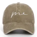 Detailed macro view of a khaki washed cotton baseball cap with white cursive me embroidery - Adjustable / Khaki