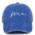 Close-up of blue washed cotton baseball cap with white 'me' embroidery - Adjustable / Sapphire Blue