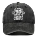 Close-up front detail of the 90th birthday embroidered washed cotton baseball cap - Adjustable / Black
