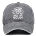 Detail of the embroidered 90th birthday message on a gray washed cotton baseball cap. - Adjustable / Gray