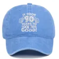 Detailed view of the '90 Years' embroidery on a blue distressed cotton baseball cap. - Adjustable / Light Blue
