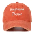Close-up detail of Fiancé white embroidery on a washed vintage coral baseball cap - Adjustable / Orange (Fiance)
